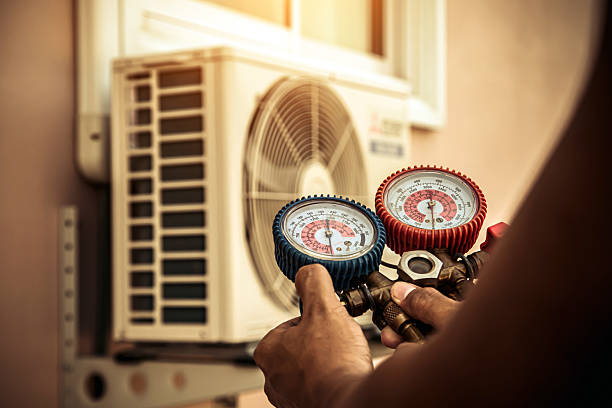 Professional Air Conditioning Service technician working in Robertsville, MO
